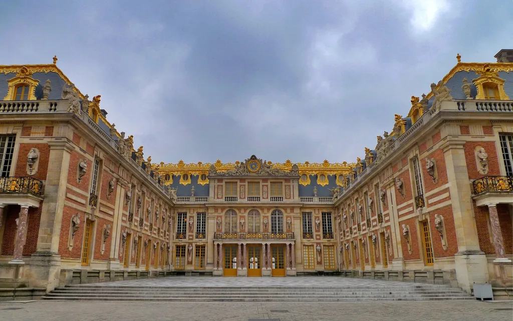 Baroque architecture – Versailles Hall of Mirrors dripping in gold and drama.
